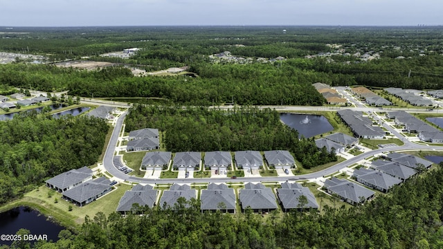 birds eye view of property with a forest view and a water view