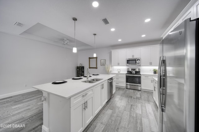 kitchen with ceiling fan, a sink, light wood-style flooring, stainless steel appliances, and recessed lighting