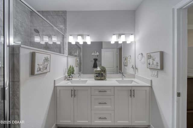 bathroom featuring double vanity, a sink, and a tile shower