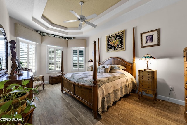 4 Arika At Lionspaw, Daytona Beach, FL 32124 - bedroom featuring a raised ceiling, wood finished floors, and a ceiling fan
