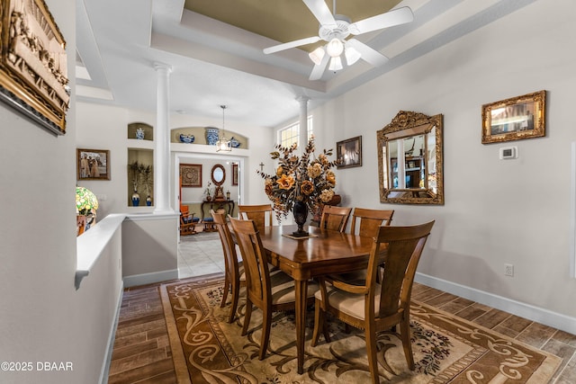 4 Arika At Lionspaw, Daytona Beach, FL 32124 - dining space featuring decorative columns, a tray ceiling, and wood finished floors