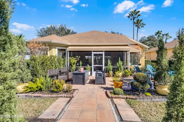4 Arika At Lionspaw, Daytona Beach, FL 32124 - rear view of property featuring a patio, outdoor lounge area, roof with shingles, stucco siding, and a sunroom