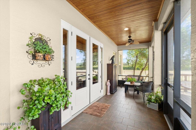 sunroom featuring ceiling fan, french doors, and wood ceiling