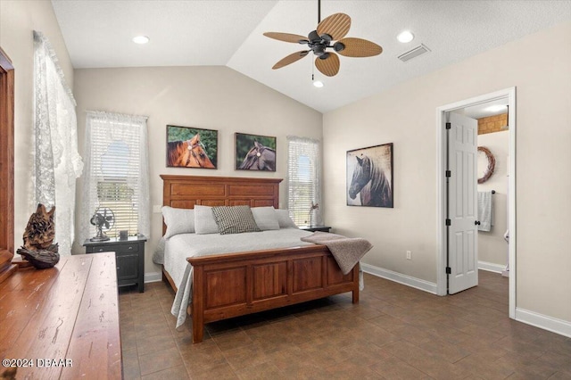 bedroom with ceiling fan, ensuite bathroom, and vaulted ceiling