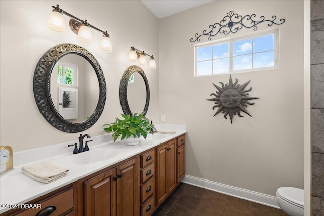 bathroom with tile patterned flooring, vanity, and toilet