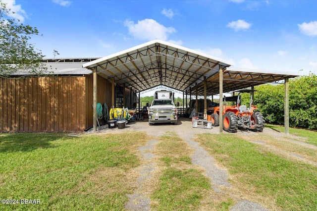 view of parking with a yard and a carport