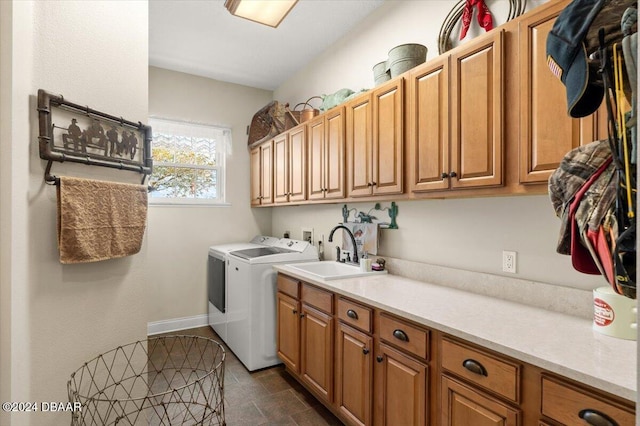 laundry room featuring washer and clothes dryer, cabinets, and sink