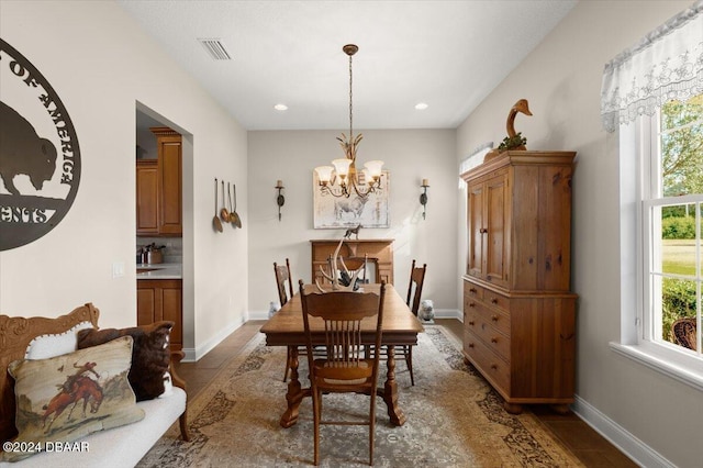 dining space with a healthy amount of sunlight and a notable chandelier