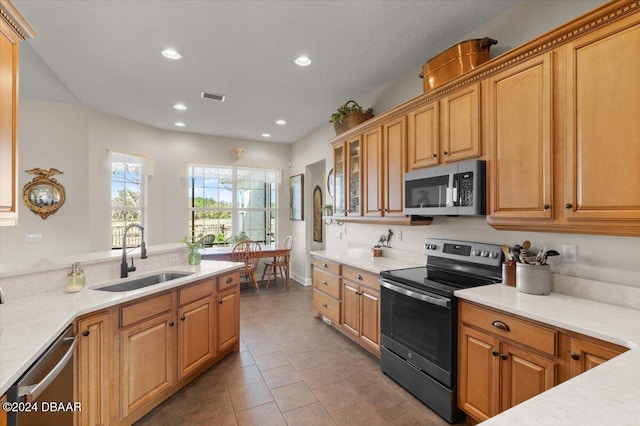 kitchen featuring appliances with stainless steel finishes, tile patterned floors, and sink