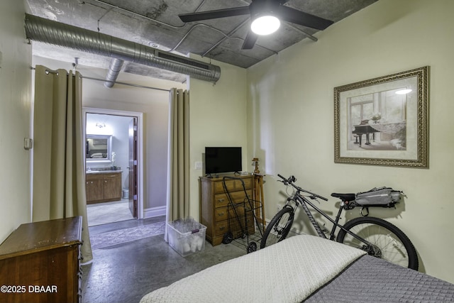 bedroom with ceiling fan, connected bathroom, and finished concrete floors