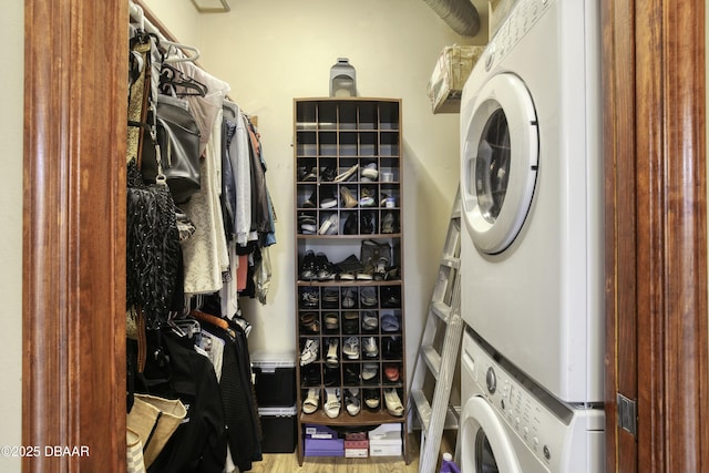 clothes washing area with laundry area and stacked washing maching and dryer