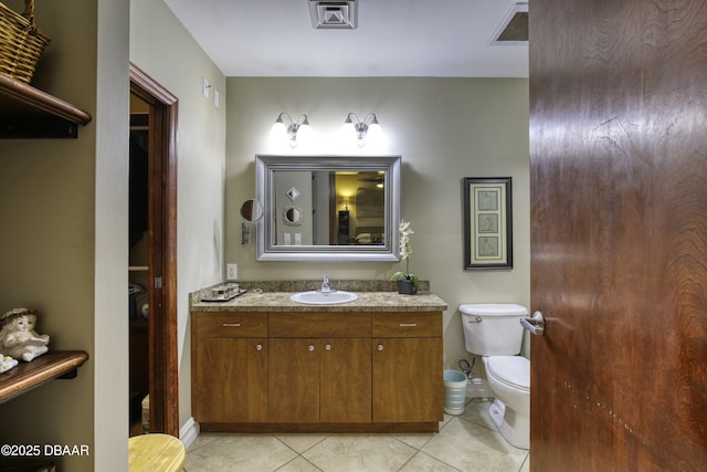 bathroom featuring visible vents, toilet, vanity, and tile patterned flooring