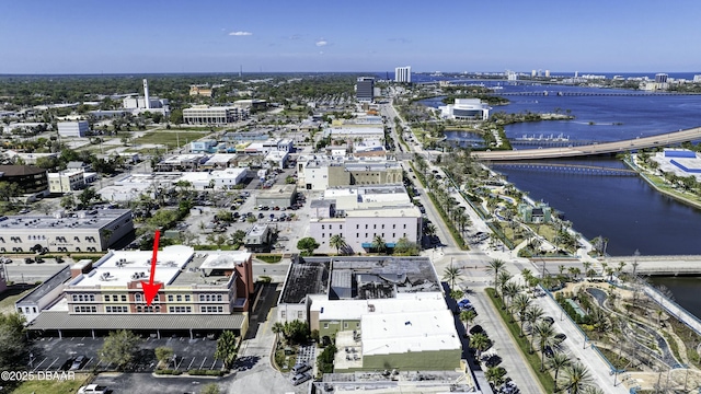 birds eye view of property with a view of city and a water view