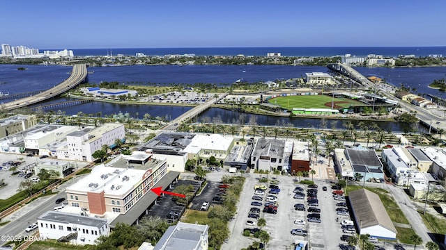 drone / aerial view featuring a view of city and a water view