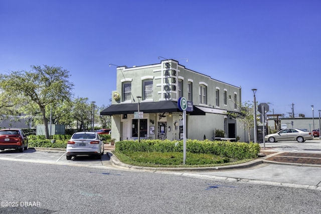 view of property featuring uncovered parking