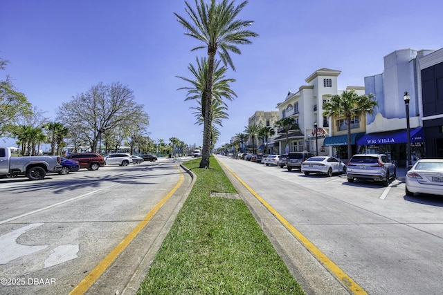 view of road with curbs, street lights, and sidewalks