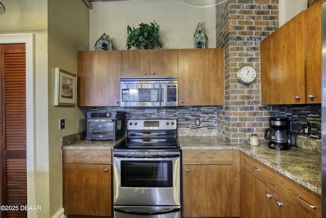 kitchen featuring backsplash, brown cabinets, and appliances with stainless steel finishes