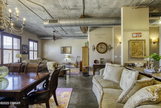 dining space featuring finished concrete flooring, visible vents, and a chandelier