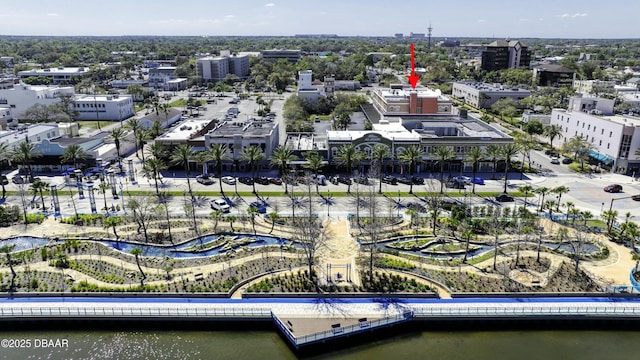 birds eye view of property featuring a city view and a water view