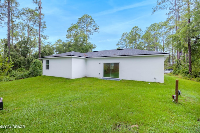 rear view of house with a lawn