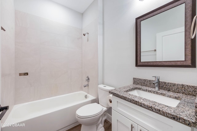 full bathroom with vanity, toilet, and tiled shower / bath