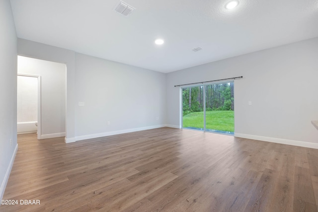 unfurnished room with light hardwood / wood-style flooring