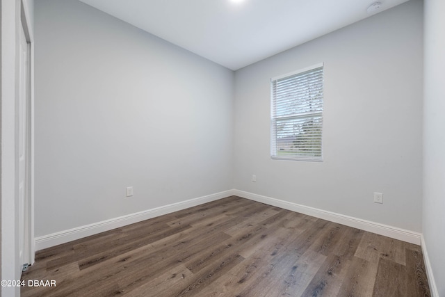 unfurnished room featuring dark wood-type flooring