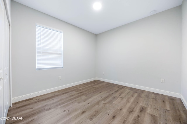 spare room with light hardwood / wood-style floors and a healthy amount of sunlight