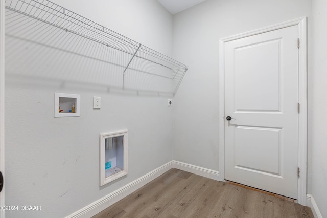 clothes washing area with washer hookup, hookup for an electric dryer, and light hardwood / wood-style flooring