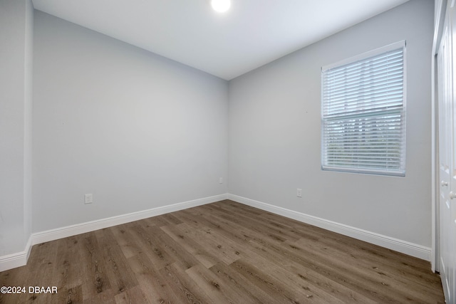 unfurnished room with wood-type flooring