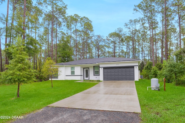 ranch-style house featuring a garage and a front yard