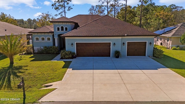 mediterranean / spanish house with a front yard and a garage