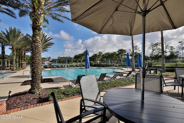 18 Landings Ln, Ormond Beach, FL 32174 - community pool featuring a patio and outdoor dining space