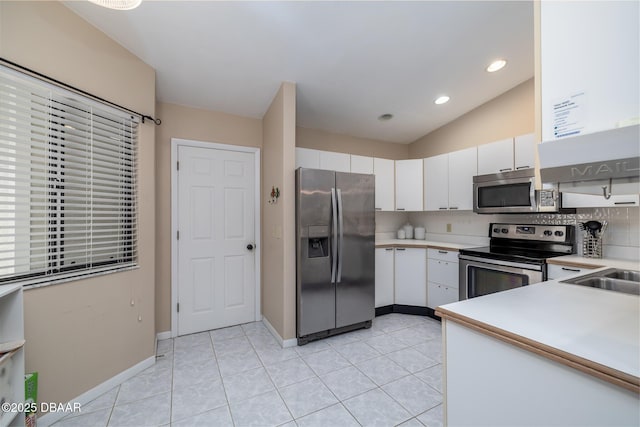 18 Landings Ln, Ormond Beach, FL 32174 - kitchen with stainless steel appliances, light countertops, white cabinetry, light tile patterned floors, and recessed lighting