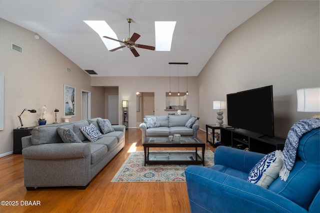 18 Landings Ln, Ormond Beach, FL 32174 - living area featuring high vaulted ceiling, light wood-type flooring, a skylight, baseboards, and a ceiling fan