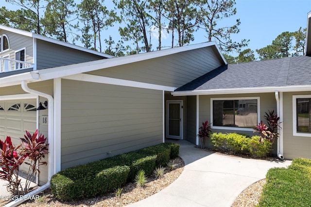 18 Landings Ln, Ormond Beach, FL 32174 - property entrance featuring roof with shingles and a garage