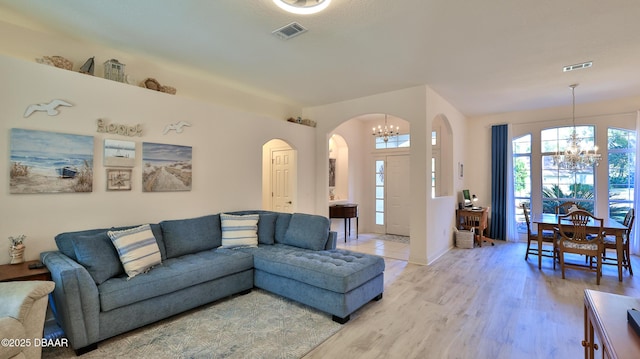 living room featuring hardwood / wood-style flooring and a chandelier