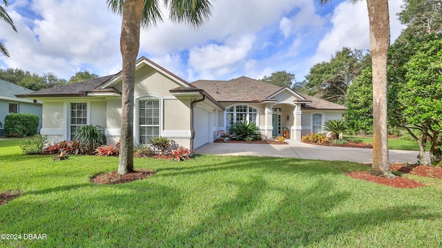 ranch-style home featuring a garage and a front lawn