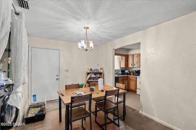 dining room with a chandelier, visible vents, a textured wall, and a textured ceiling