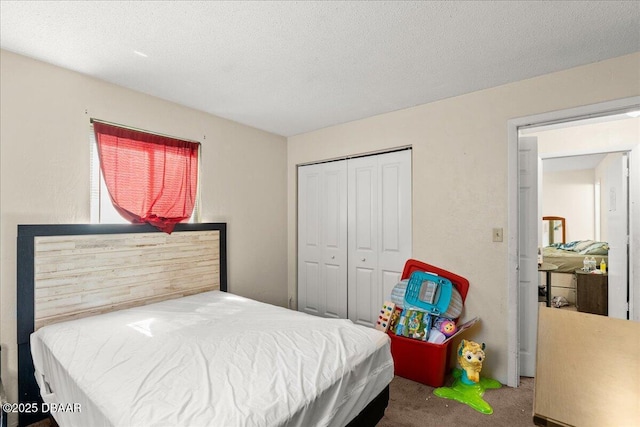 bedroom featuring a closet, carpet flooring, and a textured ceiling