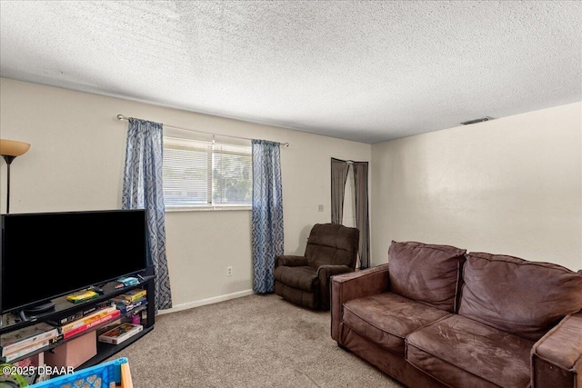 carpeted living room with visible vents, a textured ceiling, and baseboards