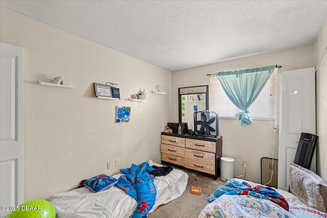 carpeted bedroom with a textured ceiling and a textured wall