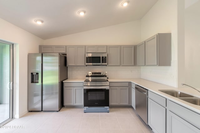 kitchen with gray cabinets, lofted ceiling, and stainless steel appliances