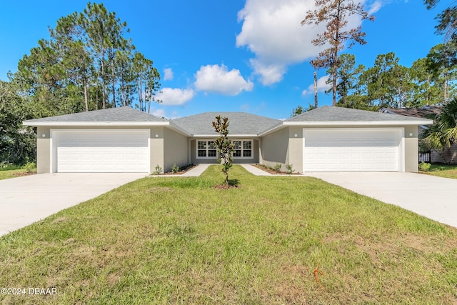 single story home featuring a garage and a front lawn