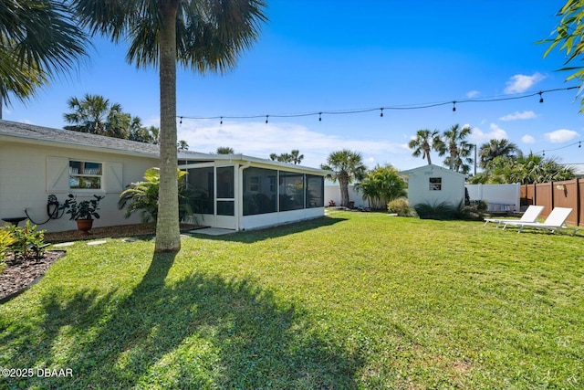 view of yard with a sunroom and fence