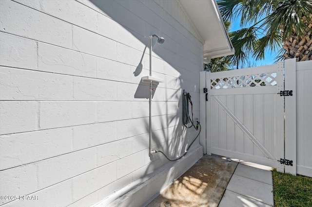 exterior space with a gate and concrete block siding