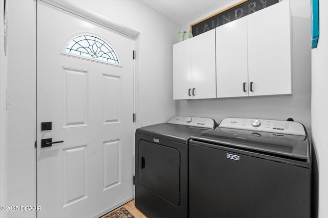 laundry area featuring washer and dryer and cabinet space