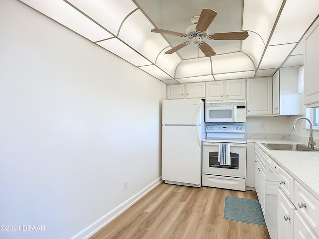 kitchen with white appliances, sink, ceiling fan, light wood-type flooring, and white cabinetry