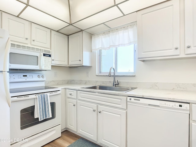 kitchen with sink, white cabinets, white appliances, and light wood-type flooring