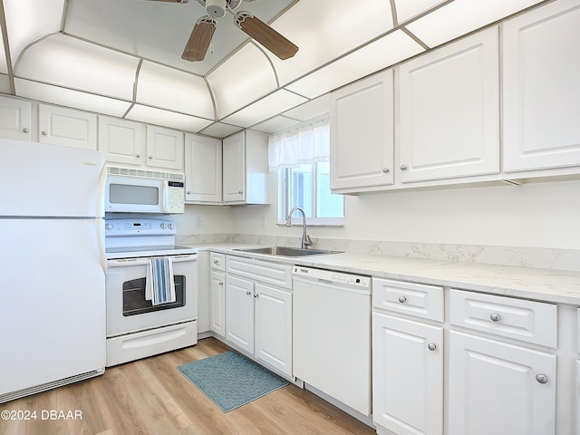 kitchen with white appliances, sink, ceiling fan, light wood-type flooring, and white cabinetry